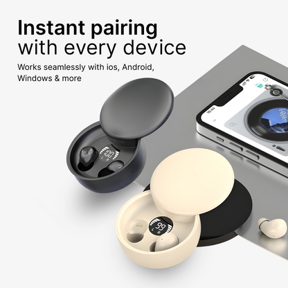 Product photography of two open wireless earbud charging cases, one black showing 100% battery and one cream showing 99% battery, displayed with a white smartphone playing music on a clean grey surface with "Instant pairing" text