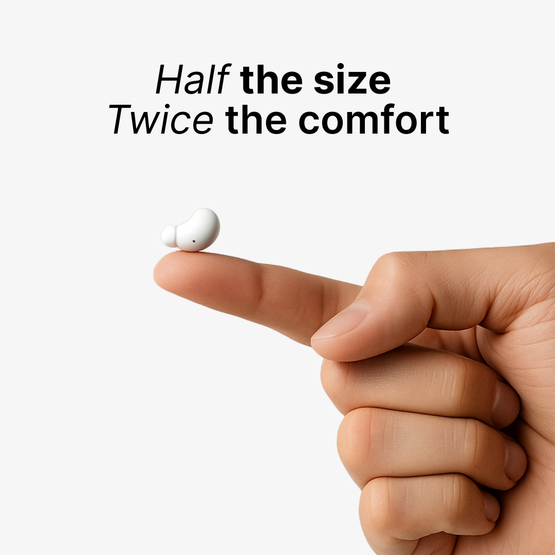 Photograph of a tiny white bean-shaped earbud balancing on a human index fingertip against a clean white background with the overlay text Half the size Twice the comfort